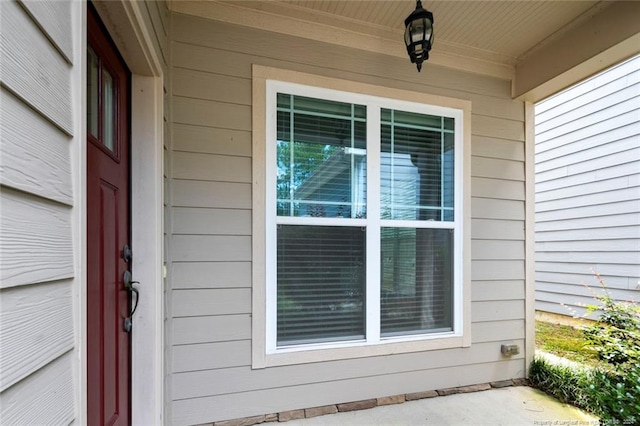 view of exterior entry with a porch