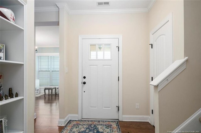 entrance foyer featuring crown molding and hardwood / wood-style floors