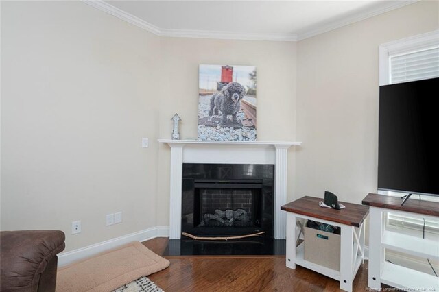 living room featuring crown molding and hardwood / wood-style flooring