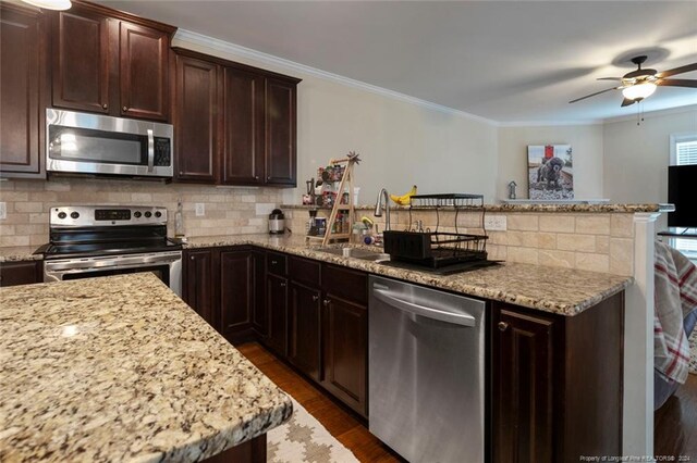 kitchen featuring appliances with stainless steel finishes, decorative backsplash, dark hardwood / wood-style floors, and ceiling fan