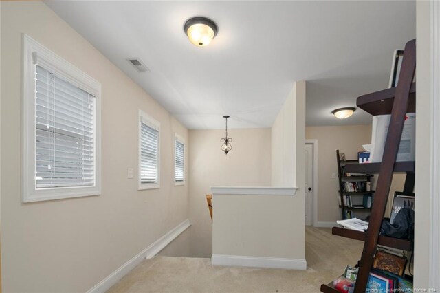 corridor with light colored carpet