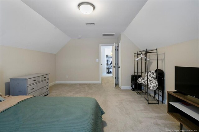 carpeted bedroom featuring vaulted ceiling