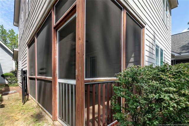 view of property exterior featuring a sunroom