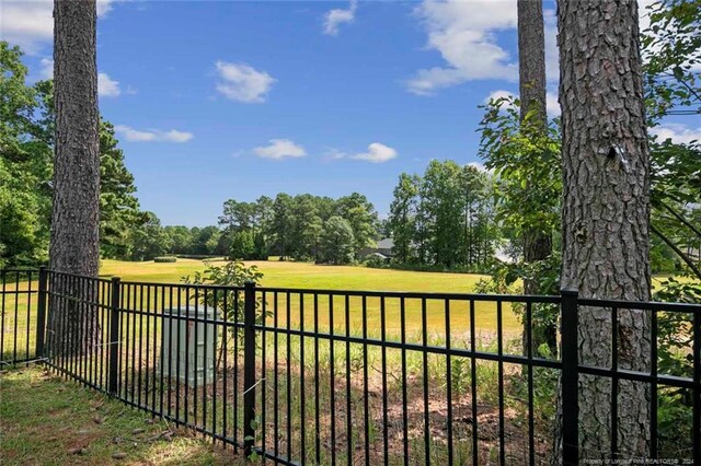 view of gate featuring a lawn