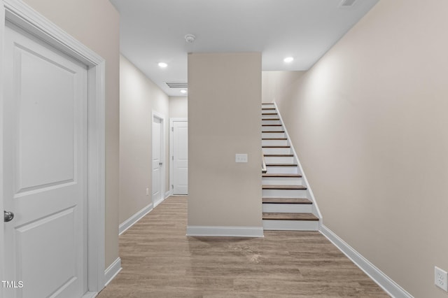 stairs featuring hardwood / wood-style floors