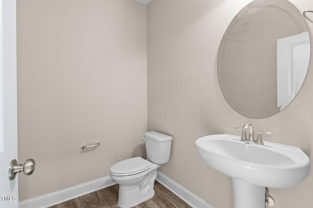 bathroom with sink, wood-type flooring, and toilet