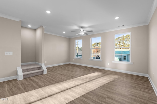 spare room with crown molding, ceiling fan, and wood-type flooring