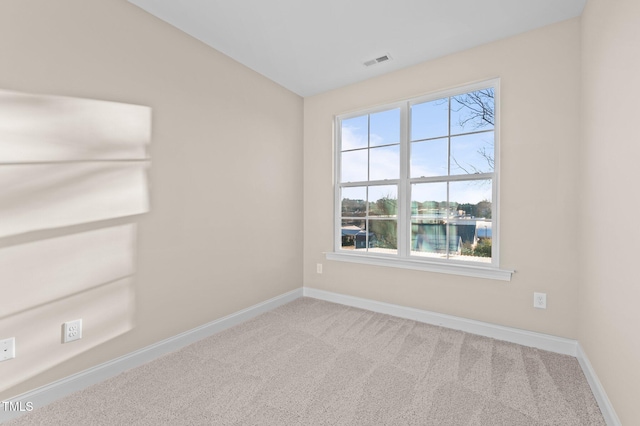 empty room featuring carpet flooring and a water view