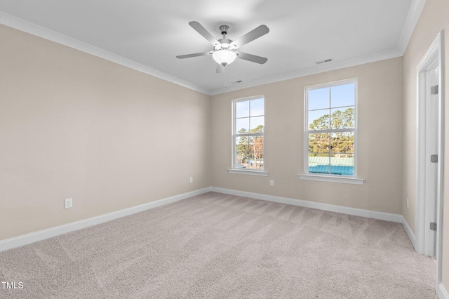 carpeted empty room featuring ceiling fan and crown molding