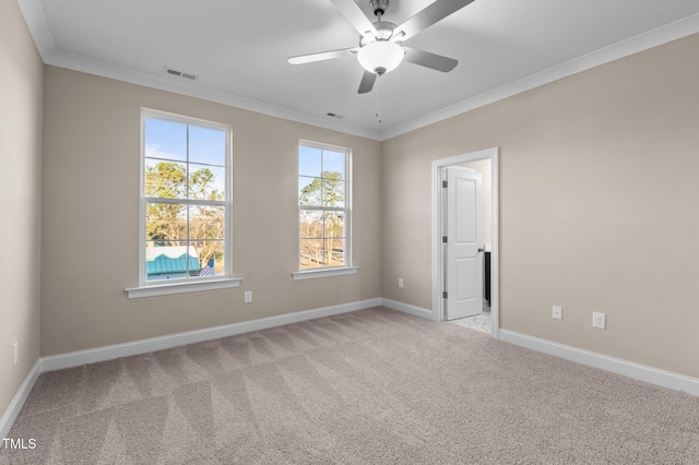 carpeted spare room featuring ceiling fan and ornamental molding