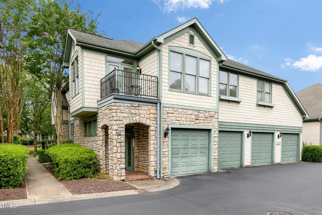 view of front of house featuring a balcony and a garage