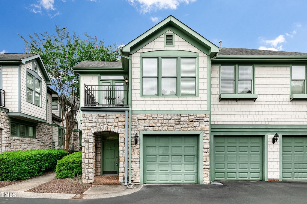 view of property with a garage and a balcony