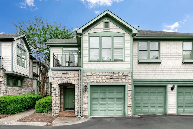 view of property with a garage and a balcony