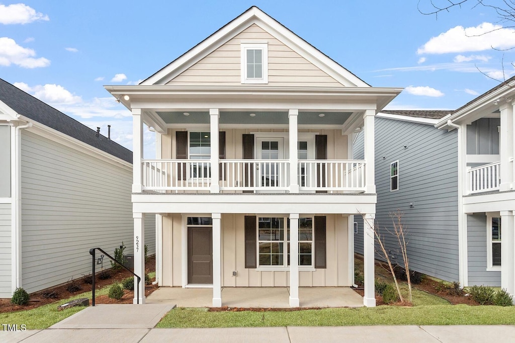 9237 Kitchin Farms Way Unit 429, Wake Forest, NC 27587 - view of front of home with board and batten siding, a balcony, and covered porch