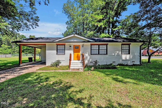 view of front of house with driveway, crawl space, a front lawn, a carport, and brick siding