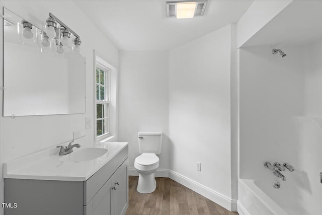 full bathroom featuring shower / bathing tub combination, vanity, toilet, and hardwood / wood-style floors