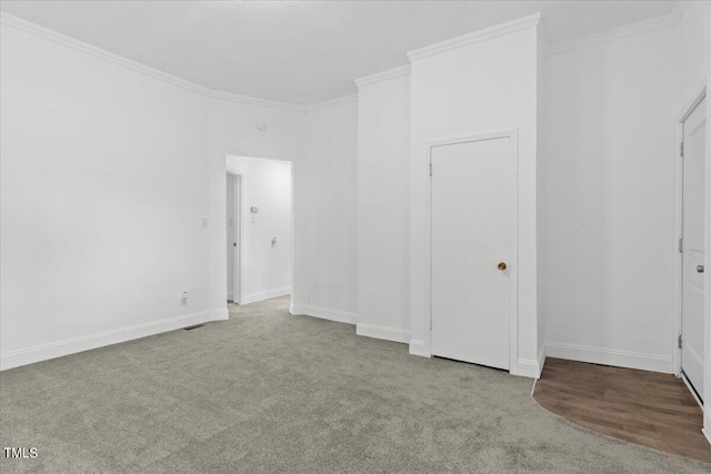 unfurnished bedroom with crown molding and light colored carpet