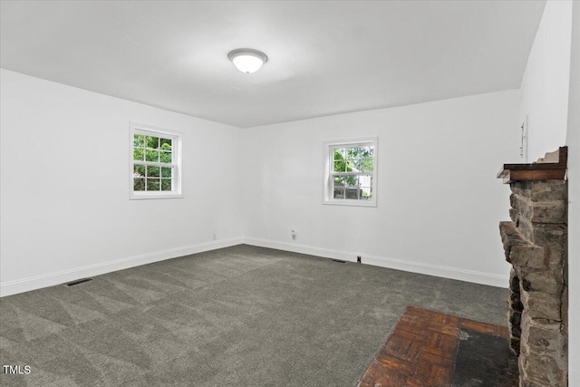 unfurnished living room with carpet flooring and a fireplace