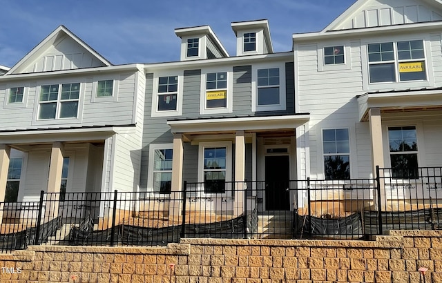 townhome / multi-family property featuring a porch and board and batten siding