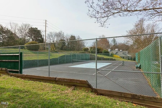 view of tennis court featuring fence