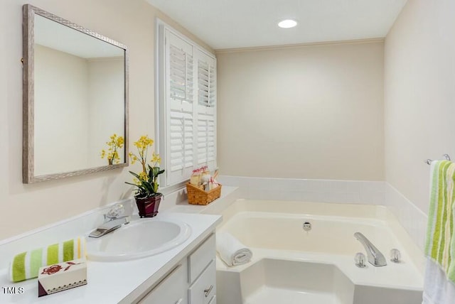 bathroom with vanity and a bath