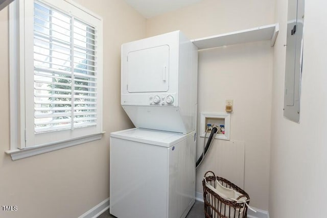 washroom featuring laundry area and stacked washer / dryer