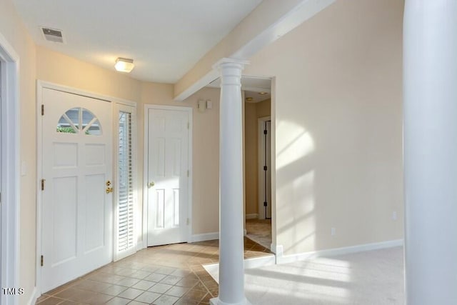 foyer with tile patterned floors, visible vents, baseboards, and decorative columns