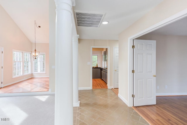 corridor with decorative columns, visible vents, and a healthy amount of sunlight