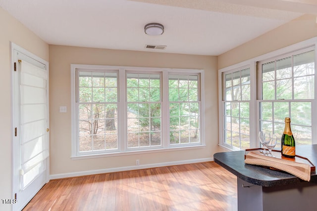 interior space featuring visible vents, baseboards, and light wood finished floors