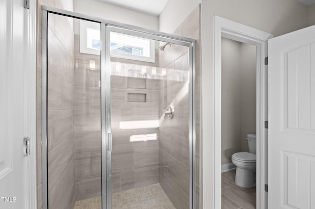 bathroom with walk in shower and toilet