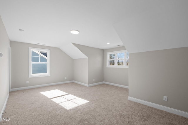 bonus room featuring light colored carpet and lofted ceiling