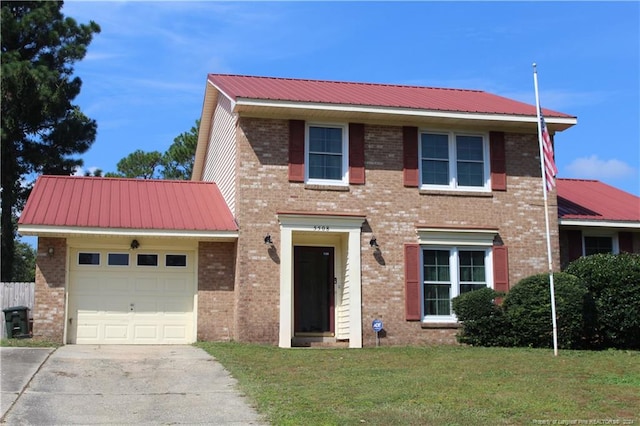 view of front of home featuring a garage and a front lawn