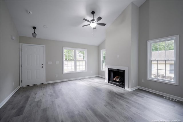 unfurnished living room featuring dark hardwood / wood-style floors, a healthy amount of sunlight, and ceiling fan