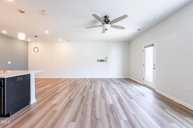 unfurnished living room featuring baseboards, recessed lighting, light wood-style flooring, and a ceiling fan