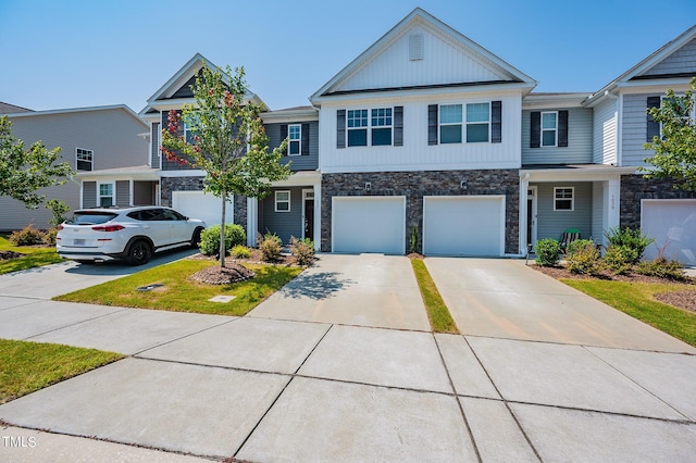 view of front facade featuring a garage, driveway, and stone siding