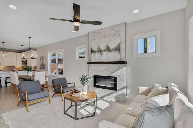 2401 E Main St, Durham, NC 27703 - living area featuring recessed lighting, ceiling fan, a high end fireplace, a chandelier, and light wood finished floors