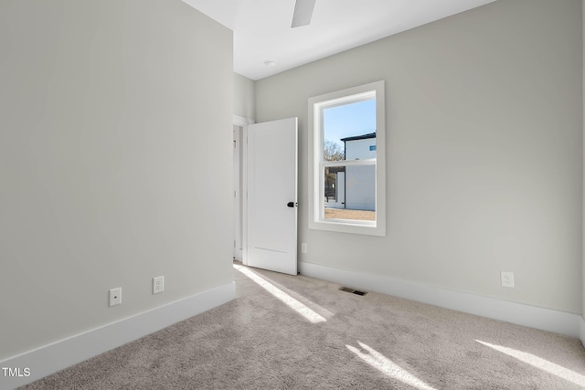 spare room featuring light carpet