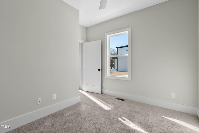 2401 E Main St, Durham, NC 27703 - carpeted empty room featuring baseboards and ceiling fan