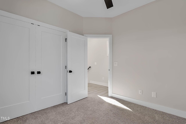 2401 E Main St, Durham, NC 27703 - unfurnished bedroom featuring light carpet, a closet, and ceiling fan