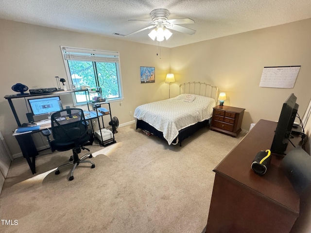 carpeted bedroom featuring a textured ceiling and ceiling fan