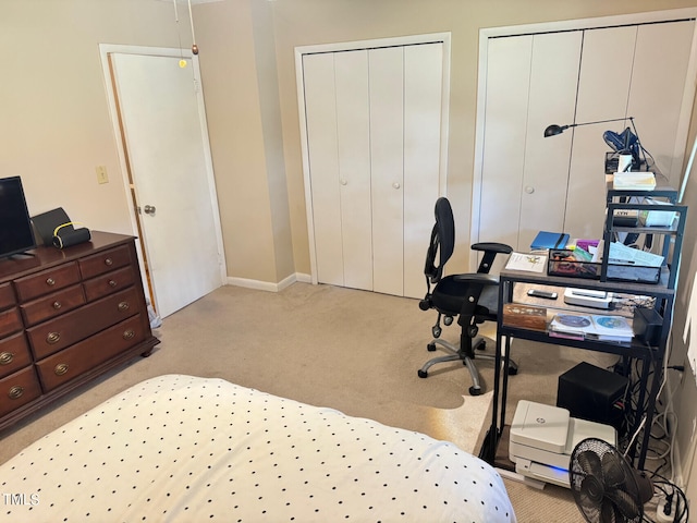 carpeted bedroom with two closets