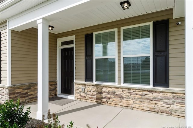 doorway to property featuring covered porch