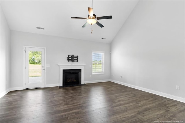 unfurnished living room with ceiling fan, dark hardwood / wood-style floors, and high vaulted ceiling