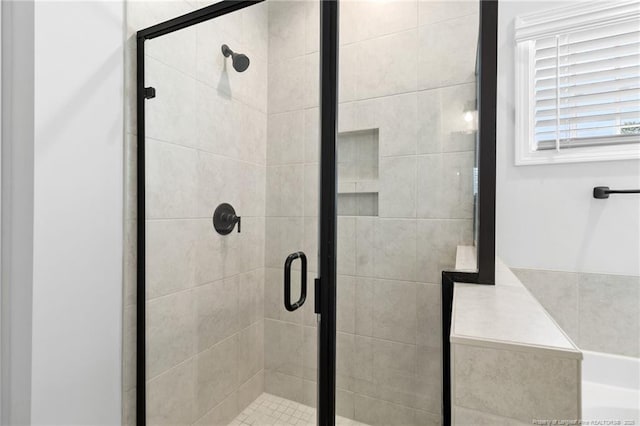 bathroom featuring a shower with shower door