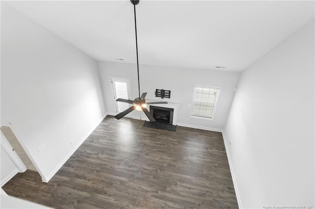 unfurnished living room featuring dark hardwood / wood-style flooring and ceiling fan