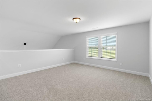 additional living space with lofted ceiling and carpet flooring