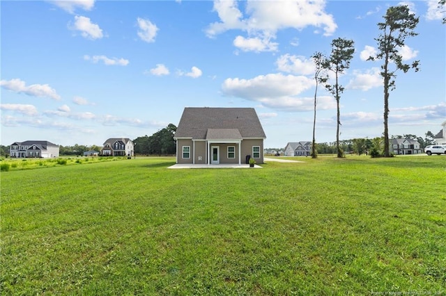 back of property featuring a yard and a patio area