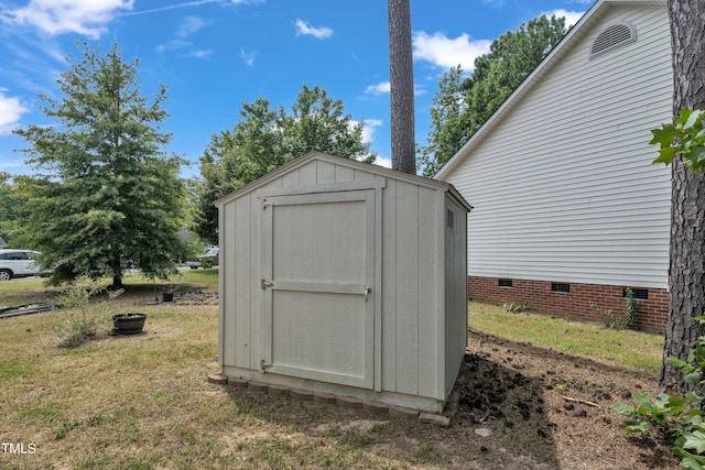 view of outbuilding with a lawn