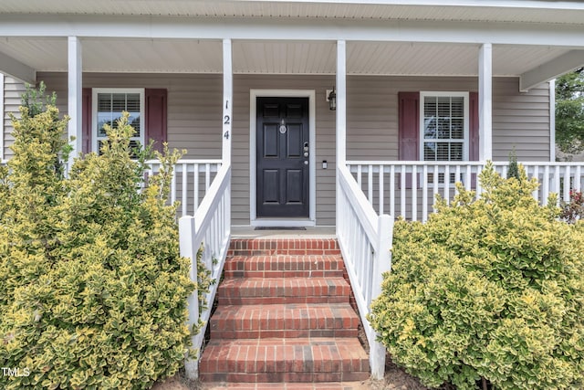 view of exterior entry featuring a porch