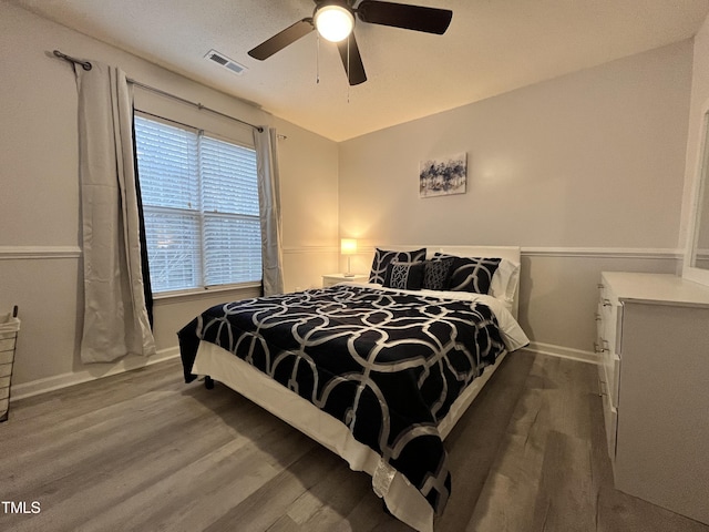 bedroom featuring hardwood / wood-style flooring and ceiling fan